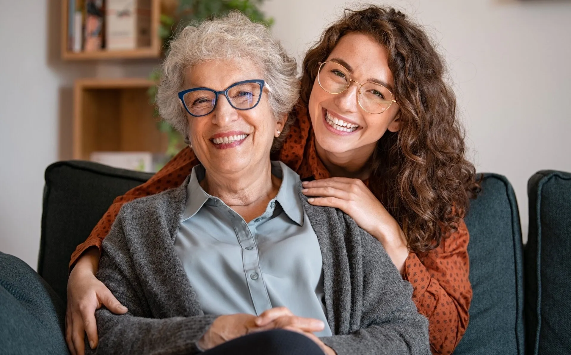 A woman and an old lady smiling for the camera.