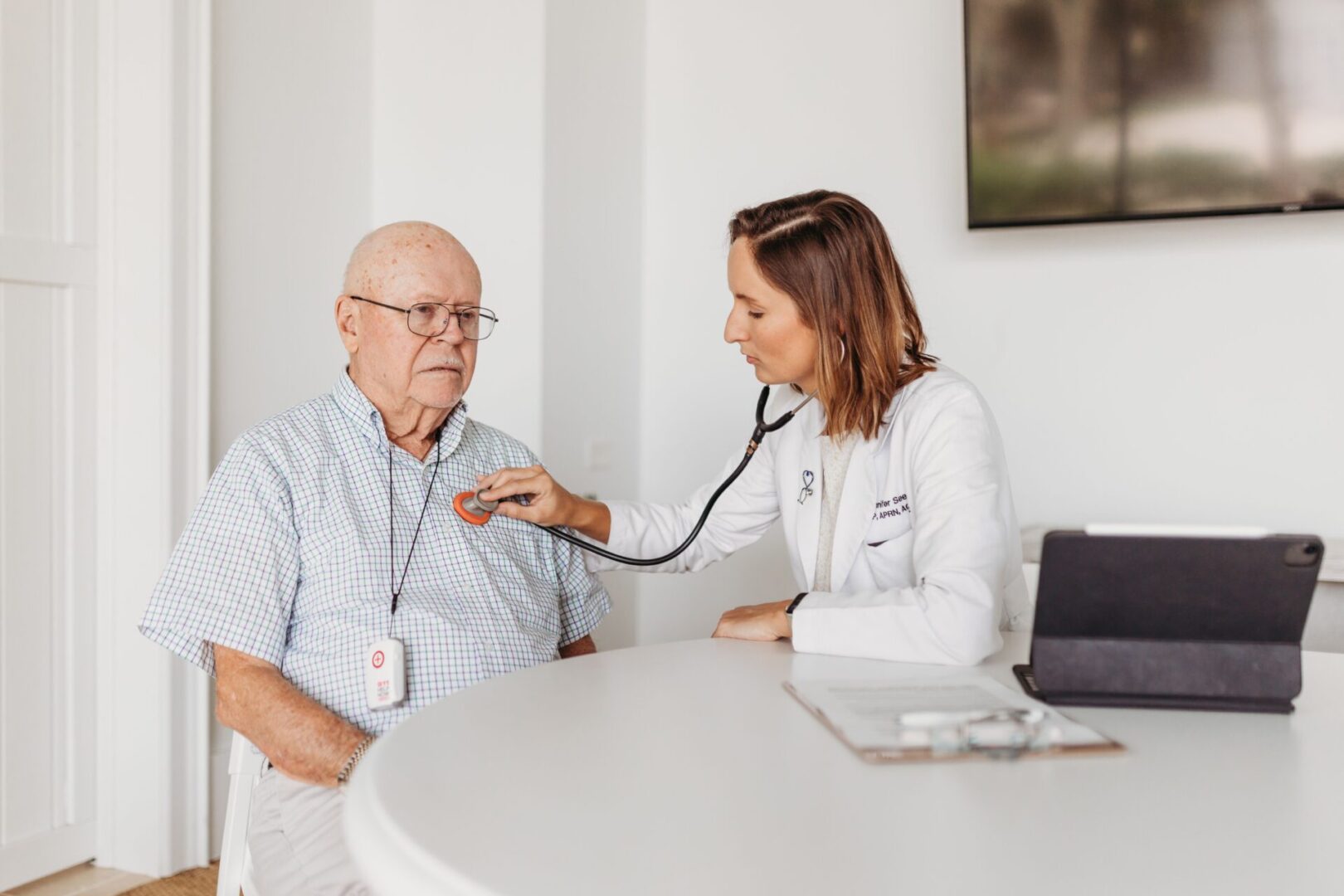 A doctor is examining an older man 's heart.