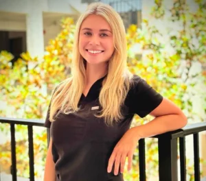 Smiling woman in black top by railing