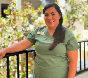 Smiling healthcare worker in green scrubs